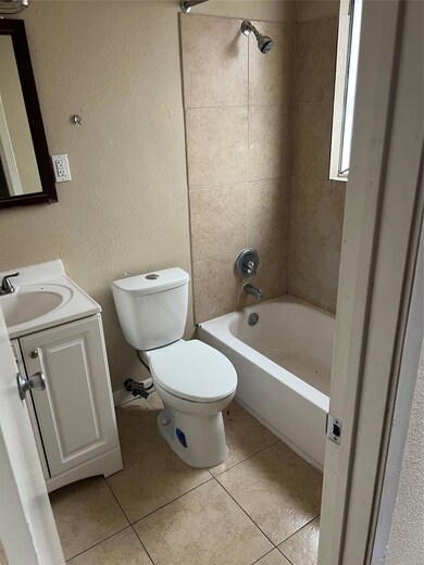 Full bath featuring tile patterned floors, toilet