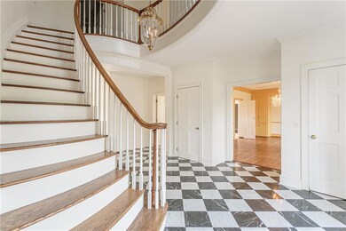 The grand 2 story foyer with marble floor and wind
