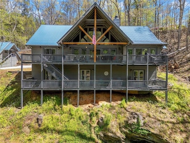 Back of property with stairway, a chimney, a deck,