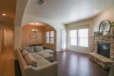 Living area featuring a fireplace, arched walkways