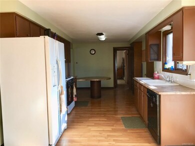 Kitchen has laminate flooring & wood Cabinets