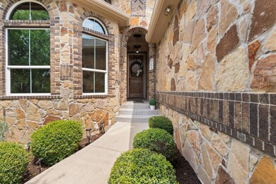 View of exterior entry featuring stone siding and