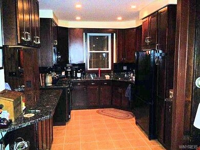 Remodeled kitchen with granite counters and cherry