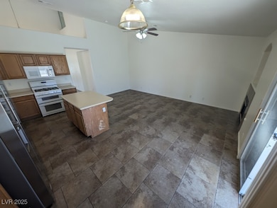 Kitchen featuring stone finish floor, brown cabine