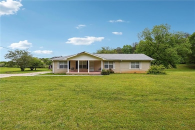Ranch-style house featuring brick siding, driveway