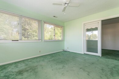 Carpeted empty room featuring ceiling fan