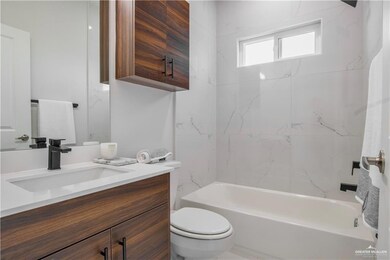 Full bathroom featuring vanity, toilet, and tiled shower / bath