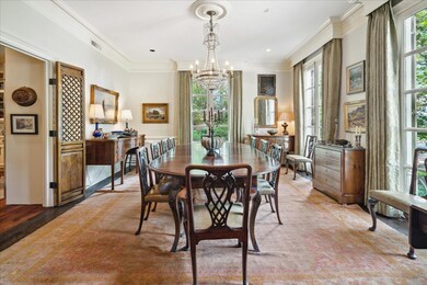 Dining area featuring crown molding, light hardwoo
