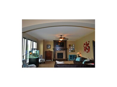 Great Room with arched entry and wall of windows.