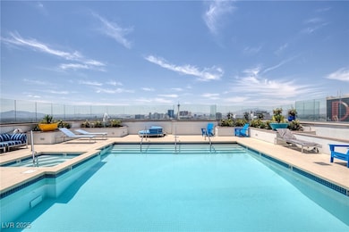 Community pool with a community hot tub and a pati