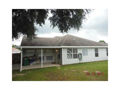 Exterior Back. Fenced yard, covered patio, storage