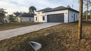 View of front of home with a garage and a front la