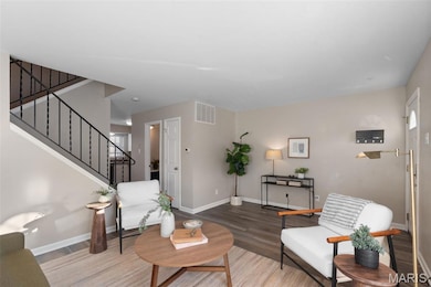 Living area featuring stairs and wood finished floors