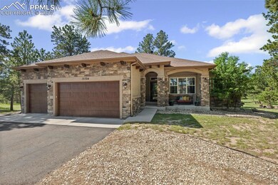 Mediterranean / spanish home featuring asphalt driveway, stone siding, an attached garage, and roof with shingles