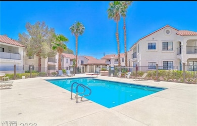 Pool with a patio area, a residential view, and fe