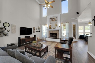 Living room with ceiling fan, a fireplace, wood fi