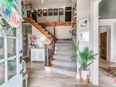Stairway featuring wood finished floors