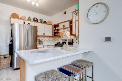 Kitchen with open shelves, appliances with stainle