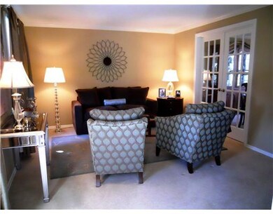 Living Room. The stylisgh living room is situated to the left of the foyer and features newer carpeting, fresh paint and french doors to the dining room.