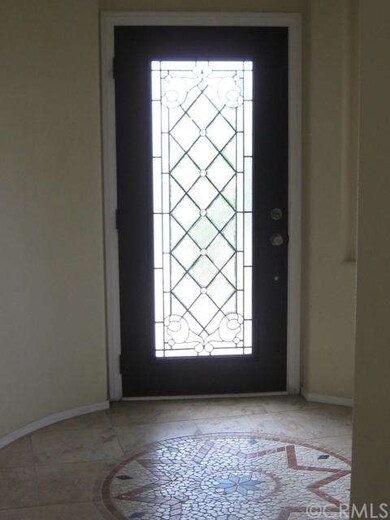 Leaded door leading to travertine & mosaic turret 