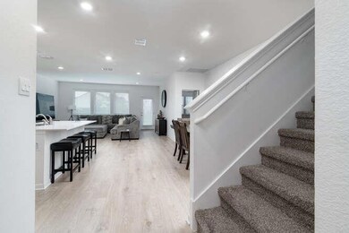 Stairway with wood finished floors and recessed l