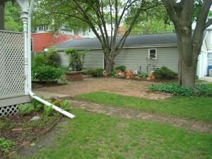 Landscaping with view of 4 car garage