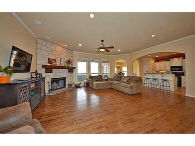 Living Room. Stone fireplace and open to kitchen. 