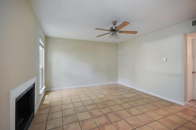 Spare room featuring a ceiling fan, baseboards, a