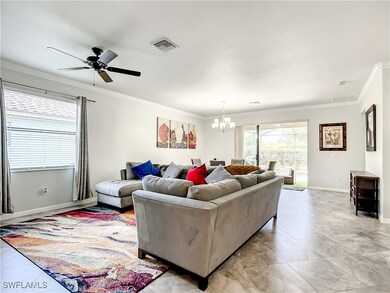 Living area with crown molding, baseboards, visibl