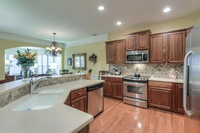 Cherry cabinets, Corian counters, and stainless steel appliances.