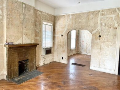 Living room with plaster walls and high ceilings