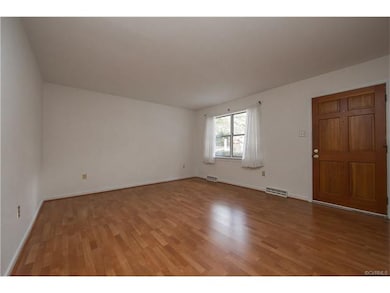 Large living room with laminate floor and double w