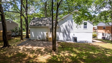 Back of property with entry steps and cooling unit
