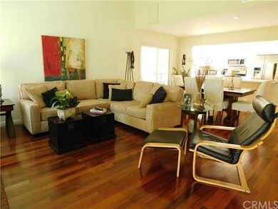 Open floor plan with hard wood flooring, vaulted c