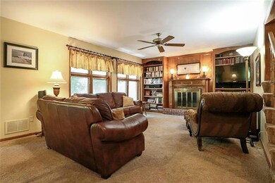 Family room with gas log fireplace and built-in bo