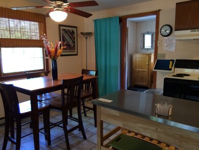 tiled kitchen- dining area leads to sunporch/office room