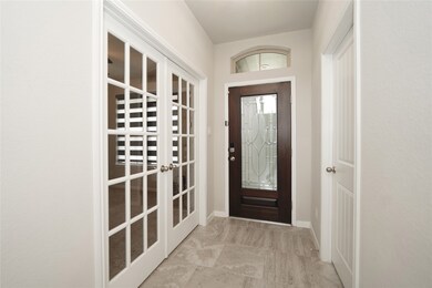 Front Door View from Atrium.  Library/Office to the left (glass doors). En-Suite to the right.