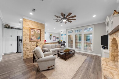 Living room featuring ceiling fan, ornamental mold