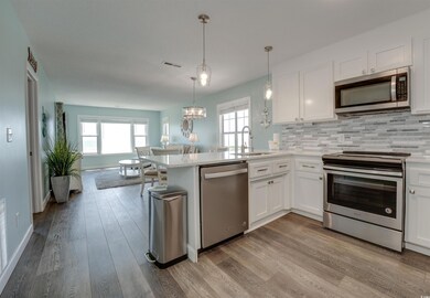 Kitchen featuring kitchen peninsula, light hardwoo