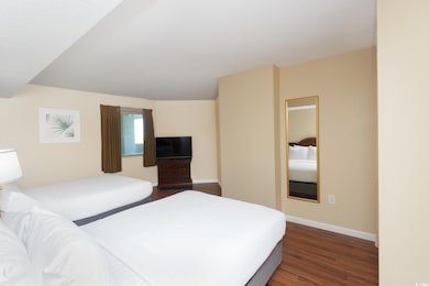 Unfurnished bedroom featuring baseboards and dark 
