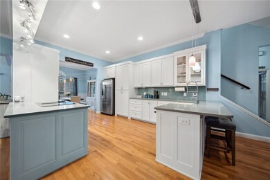 Adorned with sleek white cabinets and a tasteful accent color, the kitchen exudes a contemporary charm.
