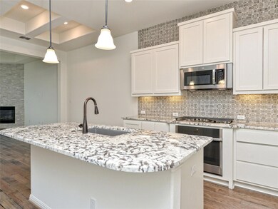Kitchen with a sink, visible vents, stainless ste