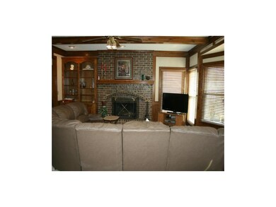 Family room boasts cozy brick fireplace, built-ins