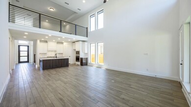 Unfurnished living room featuring baseboards, a h