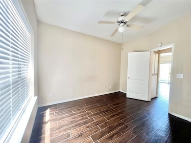 Unfurnished room featuring dark wood-style floori