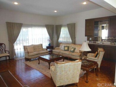 Living room features wet bar with built-ins.
