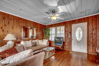 Living room featuring wood-type flooring, wood wal