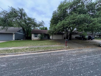 View of front of house with a front yard, an atta