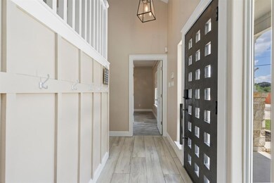 Entrance foyer with light wood-style flooring and