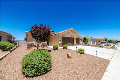 Ranch-style home with stucco siding, a garage, a t